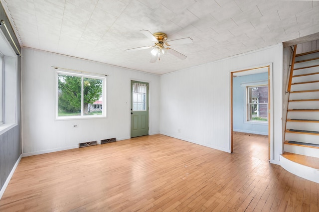 237 Main St, Walkerville, MI 49459 - empty room featuring a ceiling fan, light wood finished floors, stairs, and baseboards