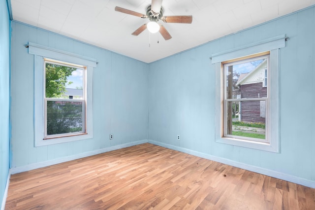 237 Main St, Walkerville, MI 49459 - unfurnished room with healthy amount of natural light, light wood-style floors, ceiling fan, and baseboards