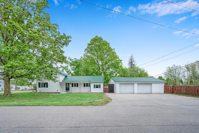 237 Main St, Walkerville, MI 49459 - view of front of house featuring a garage, an outbuilding, metal roof, and covered porch