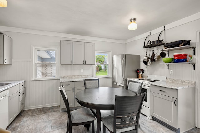 22019 Violet St, Saint Clair Shores, MI 48082 - dining area featuring a wainscoted wall and light stone finish flooring