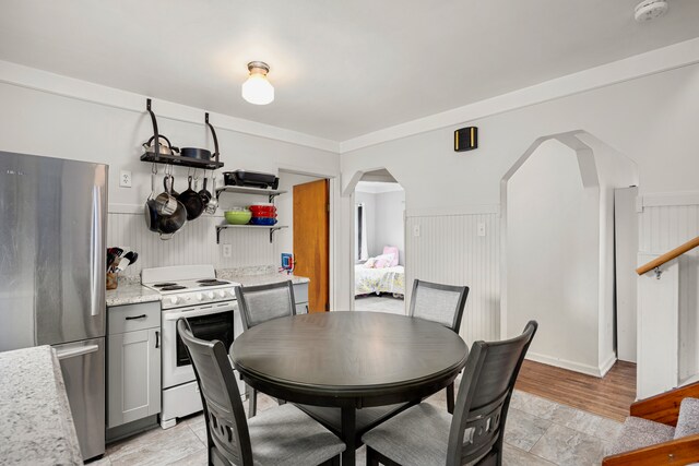 22019 Violet St, Saint Clair Shores, MI 48082 - dining area featuring arched walkways and light stone finish flooring
