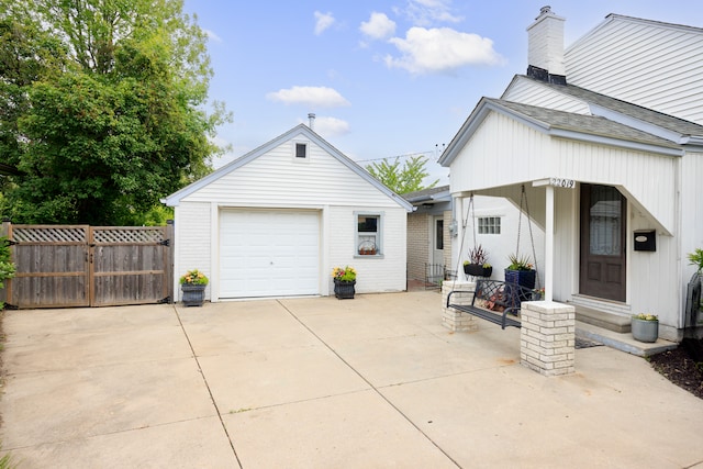 22019 Violet St, Saint Clair Shores, MI 48082 - view of side of home with an outdoor structure, a chimney, and concrete driveway