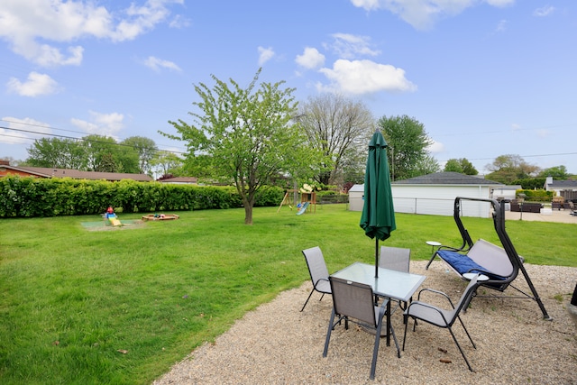 22019 Violet St, Saint Clair Shores, MI 48082 - view of yard featuring a playground, outdoor dining area, and a patio area