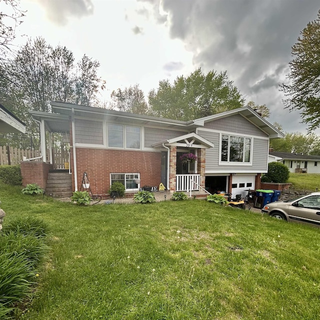 view of front of property with a garage, a front lawn, brick siding, and driveway