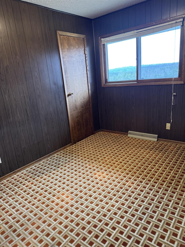 3135 Montgomery Rd, Bellaire, MI 49615 - spare room with wood walls and brick patterned flooring