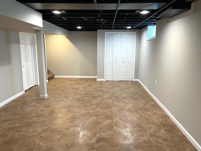 basement with stairs and baseboards