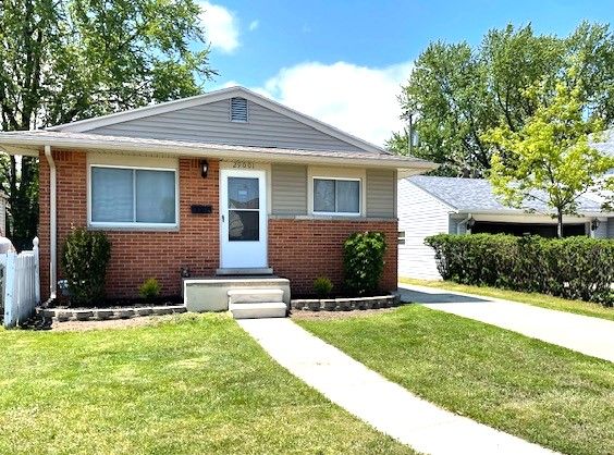bungalow-style house with brick siding