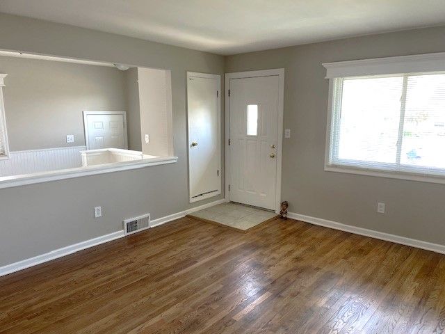 foyer with wood finished floors and baseboards
