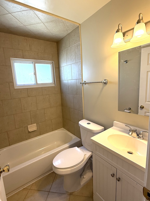 bathroom with tile patterned flooring, toilet, vanity, and washtub / shower combination