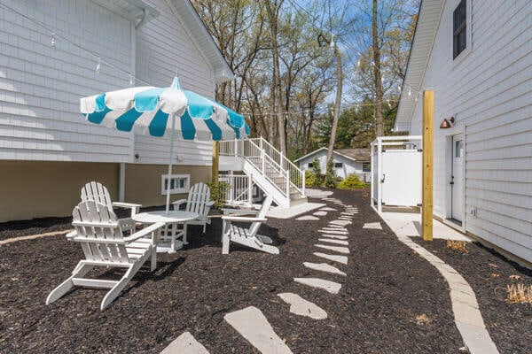 4108 Chippewa Trl, New Buffalo, MI 49117 - view of yard with stairs, a wooden deck, and a patio