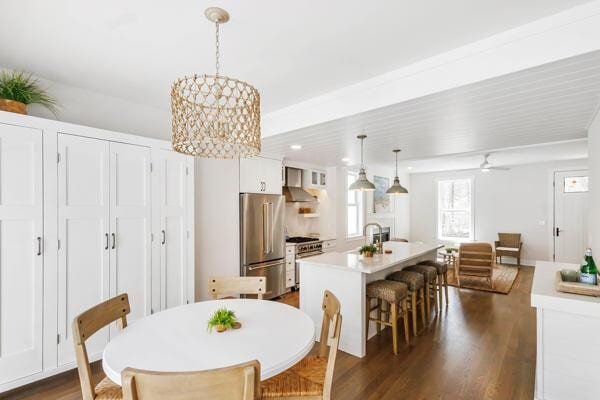 4108 Chippewa Trl, New Buffalo, MI 49117 - dining space featuring a chandelier, dark wood-type flooring, and a ceiling fan