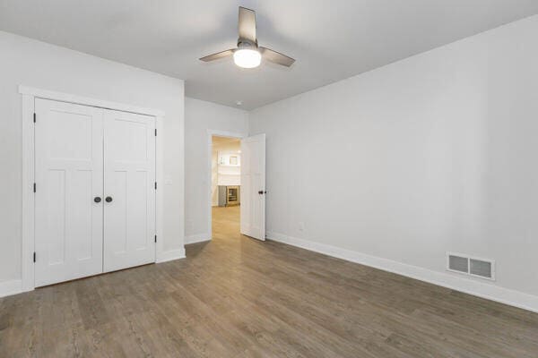 4108 Chippewa Trl, New Buffalo, MI 49117 - unfurnished bedroom with wood finished floors, baseboards, and a closet