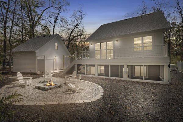 4108 Chippewa Trl, New Buffalo, MI 49117 - back of house featuring a fire pit, stairway, a deck, and a patio area