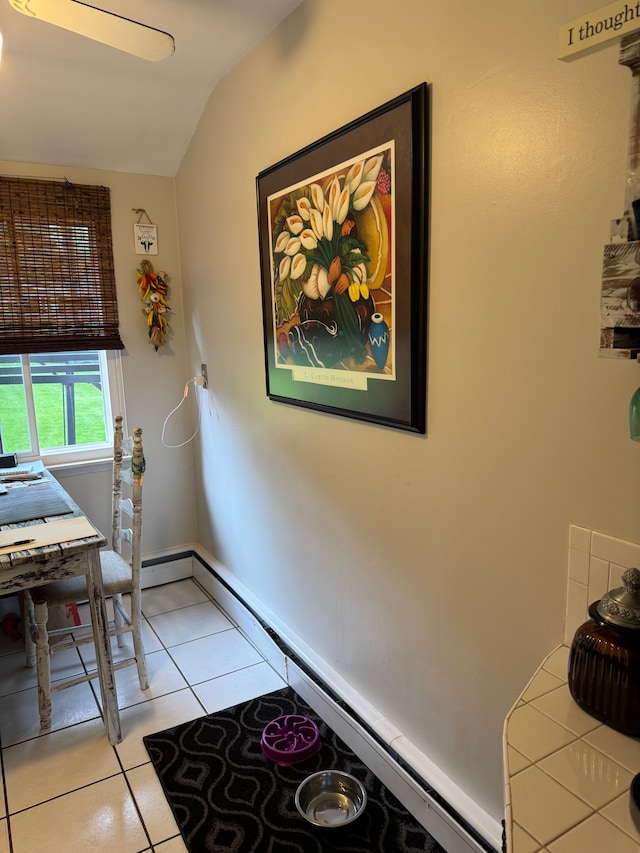 2071 N Belsay Rd, Burton, MI 48509 - entryway featuring vaulted ceiling, light tile patterned floors, and a baseboard heating unit
