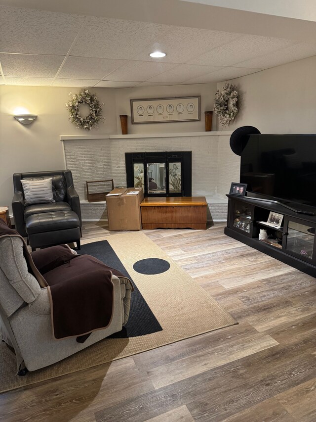 2071 N Belsay Rd, Burton, MI 48509 - living area with a brick fireplace, wood finished floors, and a drop ceiling