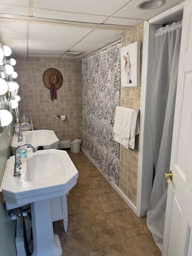 2071 N Belsay Rd, Burton, MI 48509 - bathroom featuring a sink, curtained shower, and tile walls