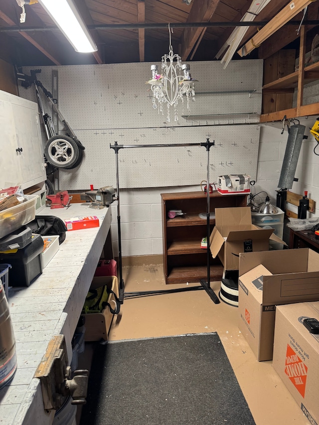 2071 N Belsay Rd, Burton, MI 48509 - below grade area featuring a workshop area and concrete block wall