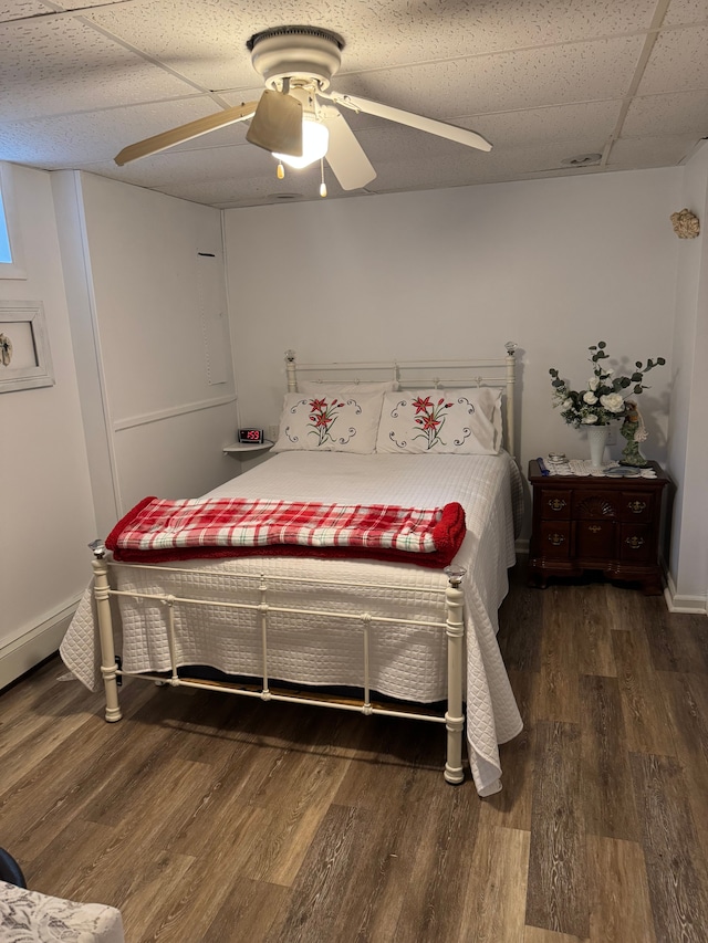 2071 N Belsay Rd, Burton, MI 48509 - bedroom featuring wood finished floors, a ceiling fan, baseboards, and a paneled ceiling