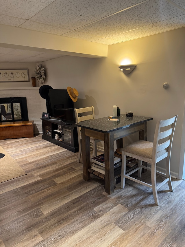 2071 N Belsay Rd, Burton, MI 48509 - dining space featuring wood finished floors and a fireplace