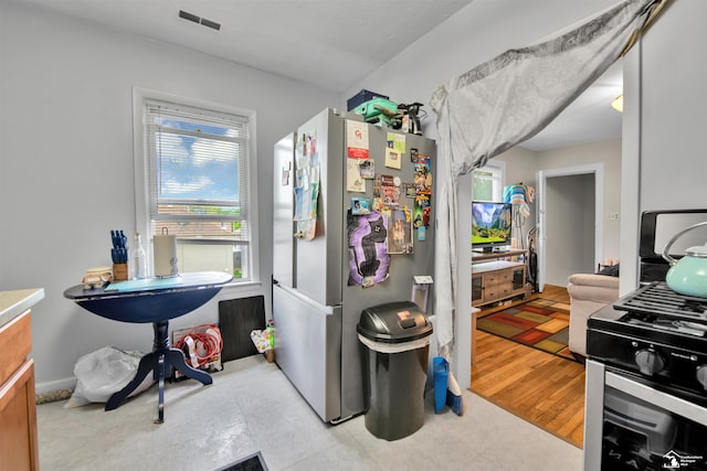 2651 5th St, Trenton, MI 48183 - kitchen featuring freestanding refrigerator and healthy amount of natural light