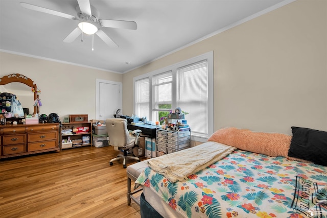 2651 5th St, Trenton, MI 48183 - bedroom with light wood-style flooring, ornamental molding, ceiling fan, and a desk