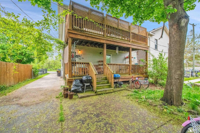 2651 5th St, Trenton, MI 48183 - back of house featuring fence, a deck, and driveway