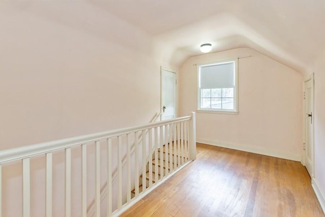 2520 S State St, Saint Joseph, MI 49085 - additional living space with lofted ceiling, wood finished floors, and baseboards