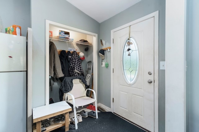 mudroom with vaulted ceiling and baseboards