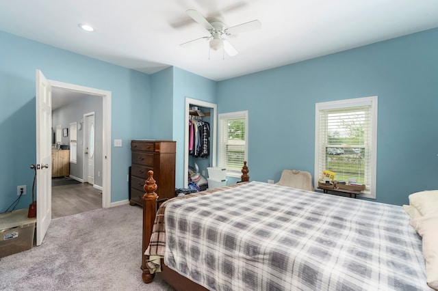 carpeted bedroom featuring multiple windows, a closet, baseboards, ceiling fan, and recessed lighting