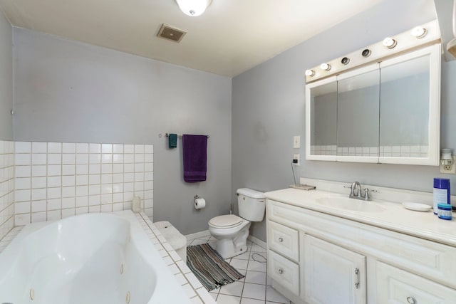 full bathroom with a whirlpool tub, toilet, tile patterned floors, vanity, and baseboards