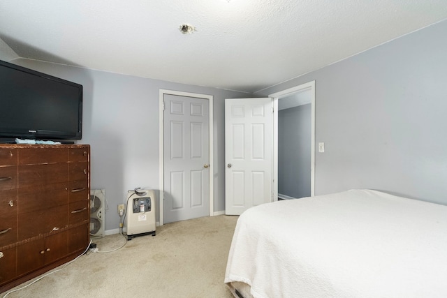 bedroom with light carpet and baseboards