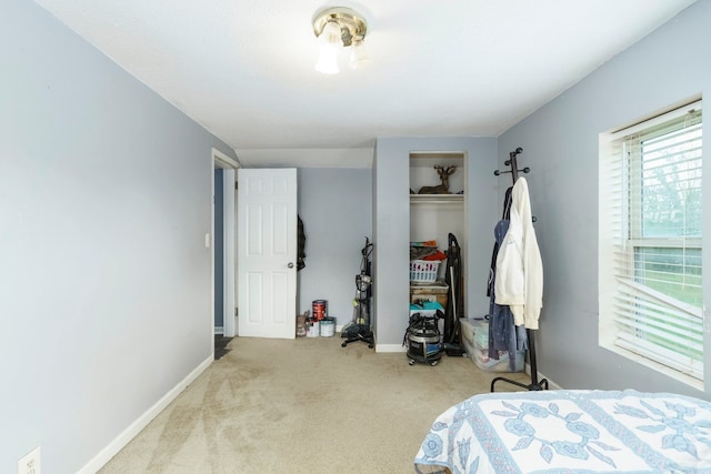bedroom with carpet, a closet, and baseboards