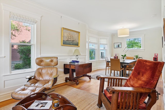 314 W Madison St, Ann Arbor, MI 48103 - sitting room with light wood-type flooring, a decorative wall, crown molding, and a wainscoted wall