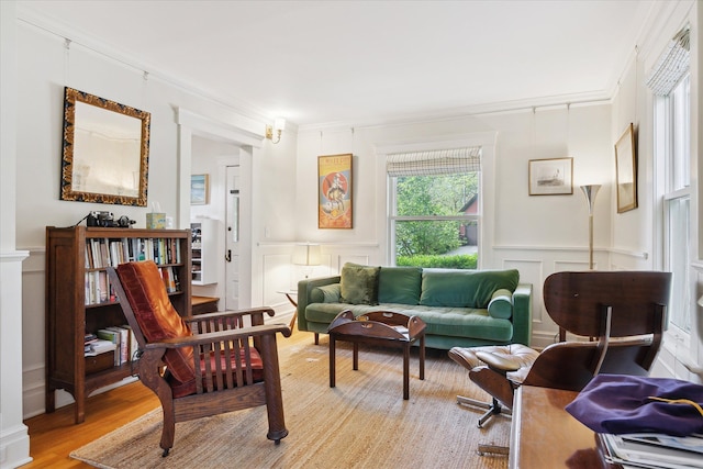 314 W Madison St, Ann Arbor, MI 48103 - living area with a decorative wall, light wood finished floors, a wainscoted wall, and crown molding