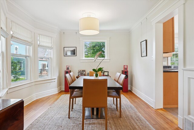 314 W Madison St, Ann Arbor, MI 48103 - dining room with light wood-style floors, ornamental molding, and baseboards