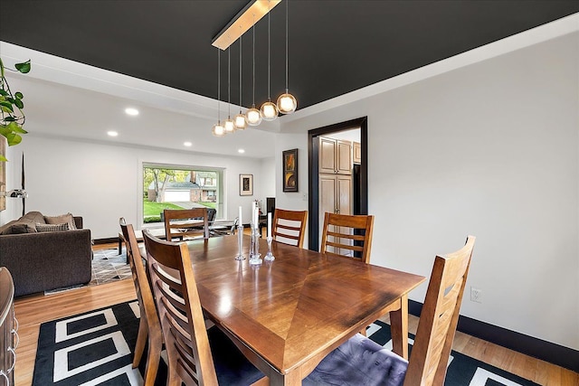 dining space with light wood-type flooring, recessed lighting, and baseboards