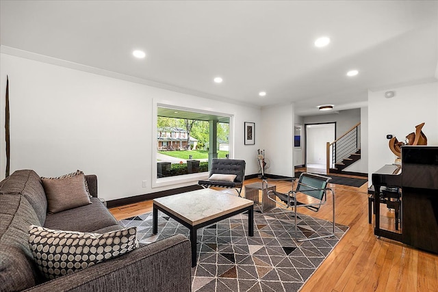 living area with recessed lighting, wood finished floors, stairway, and baseboards