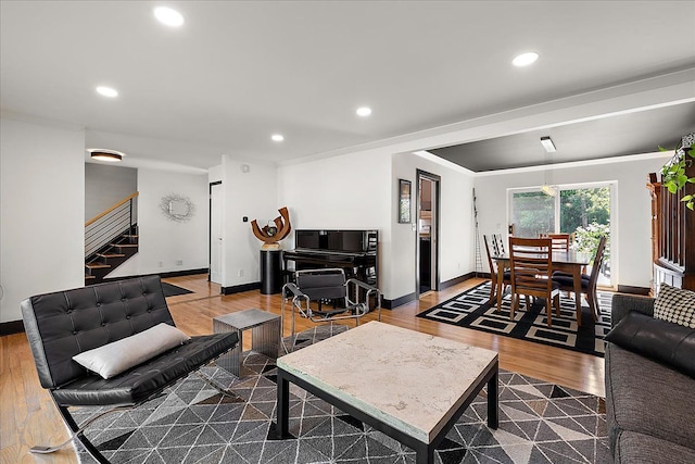 living area with stairway, baseboards, recessed lighting, wood finished floors, and crown molding
