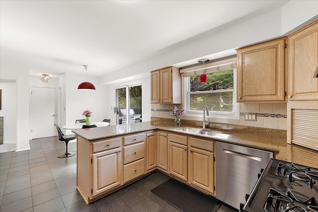 kitchen with dishwasher, a sink, light brown cabinetry, and plenty of natural light