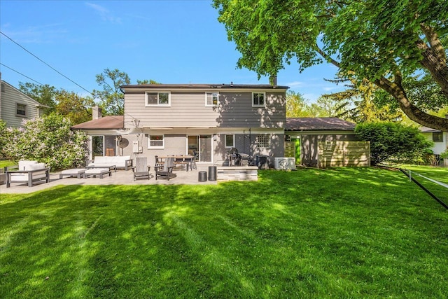 rear view of property with a patio, a yard, and an outdoor hangout area
