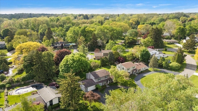 aerial overview of property's location with nearby suburban area and a forest