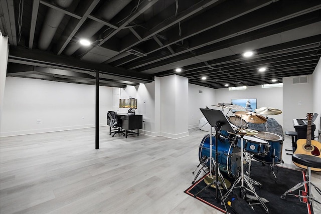 finished basement featuring wood finished floors and baseboards
