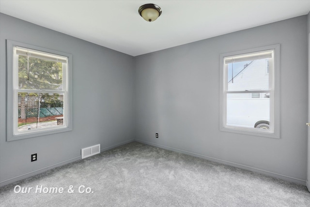 700 Scheurmann St, Essexville, MI 48732 - carpeted spare room featuring healthy amount of natural light and baseboards