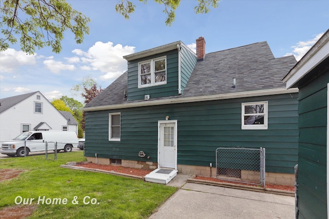 700 Scheurmann St, Essexville, MI 48732 - rear view of property with a chimney, a lawn, and a shingled roof