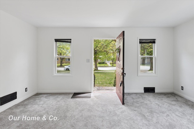 700 Scheurmann St, Essexville, MI 48732 - empty room featuring carpet flooring, plenty of natural light, and baseboards