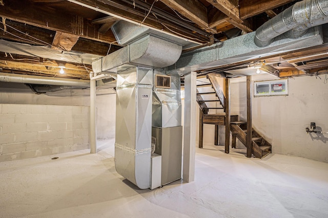 24 W Bernard St, Hartford, MI 49057 - unfinished basement featuring stairway and heating unit