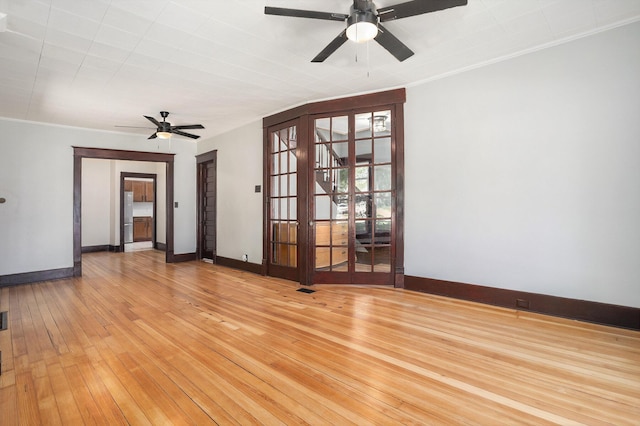 24 W Bernard St, Hartford, MI 49057 - unfurnished room featuring ceiling fan, baseboards, french doors, light wood-style floors, and ornamental molding