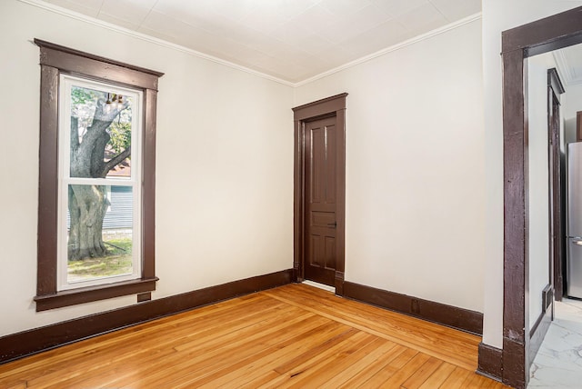 24 W Bernard St, Hartford, MI 49057 - unfurnished room with ornamental molding, baseboards, and light wood-style flooring