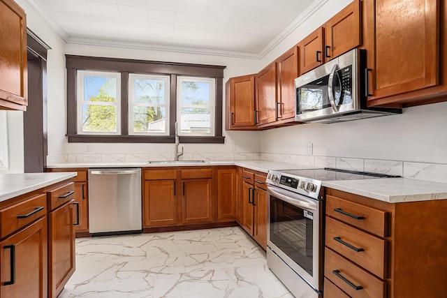 24 W Bernard St, Hartford, MI 49057 - kitchen featuring stainless steel appliances, a sink, light marble finish floors, brown cabinets, and ornamental molding