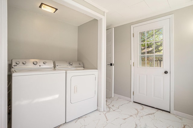 24 W Bernard St, Hartford, MI 49057 - washroom featuring separate washer and dryer, light marble finish flooring, and baseboards